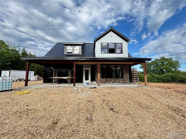 1311 County Road 4180, Salem, MO 65560 - view of front of house with board and batten siding, metal roof, stone siding, and covered porch