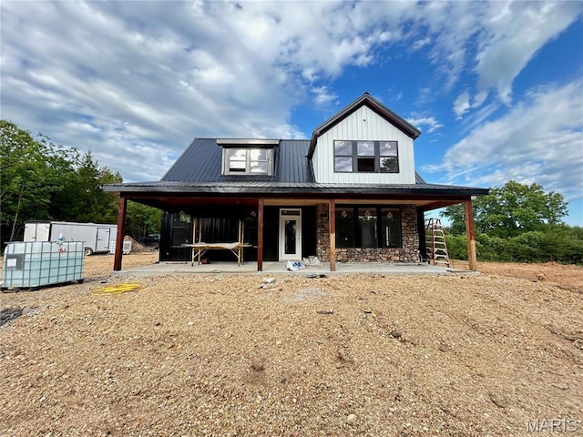 1311 County Road 4180, Salem, MO 65560 - view of front facade featuring stone siding, metal roof, board and batten siding, an outbuilding, and covered porch