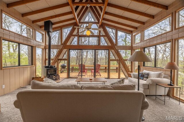 1556 Bliss Lake Dr, Innsbrook, MO 63390 - carpeted living area featuring high vaulted ceiling, a wood stove, and beam ceiling