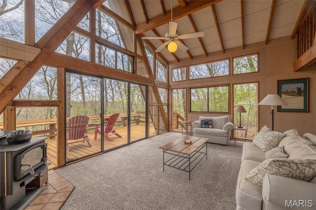 1556 Bliss Lake Dr, Innsbrook, MO 63390 - tiled living area with high vaulted ceiling, a ceiling fan, and a wood stove