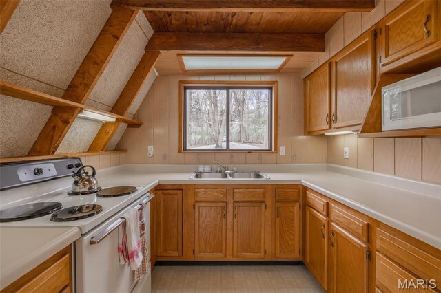 1556 Bliss Lake Dr, Innsbrook, MO 63390 - kitchen featuring white appliances, a sink, beam ceiling, light countertops, and light flooring