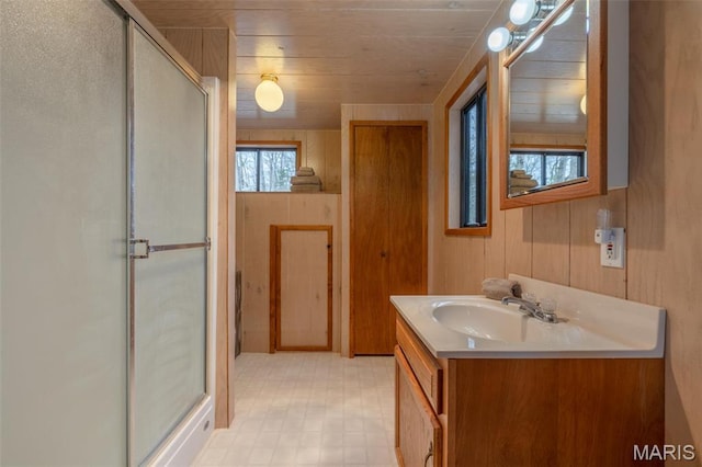 1556 Bliss Lake Dr, Innsbrook, MO 63390 - full bath featuring a shower stall, vanity, wooden walls, wooden ceiling, and tile patterned floors
