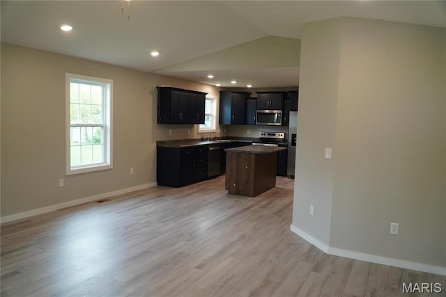 468 Polk St, Lebanon, MO 65536 - kitchen featuring appliances with stainless steel finishes, a center island, healthy amount of natural light, lofted ceiling, and light wood finished floors