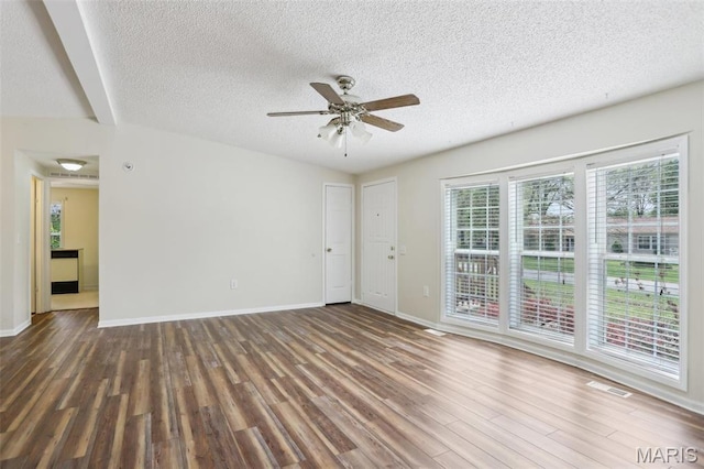 21839 Dove Ln, Carlyle, IL 62231 - spare room with wood finished floors, a textured ceiling, a ceiling fan, and baseboards
