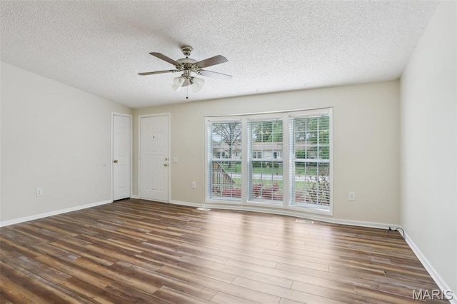 21839 Dove Ln, Carlyle, IL 62231 - unfurnished room with a textured ceiling, ceiling fan, wood finished floors, and baseboards