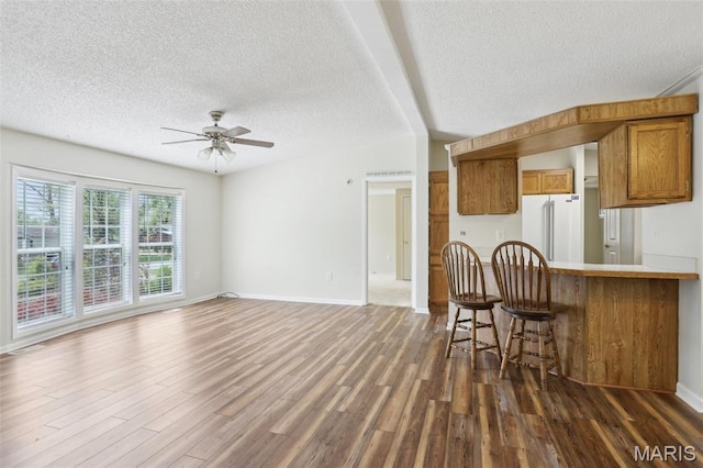 21839 Dove Ln, Carlyle, IL 62231 - living room with a textured ceiling, dark wood finished floors, a ceiling fan, baseboards, and vaulted ceiling