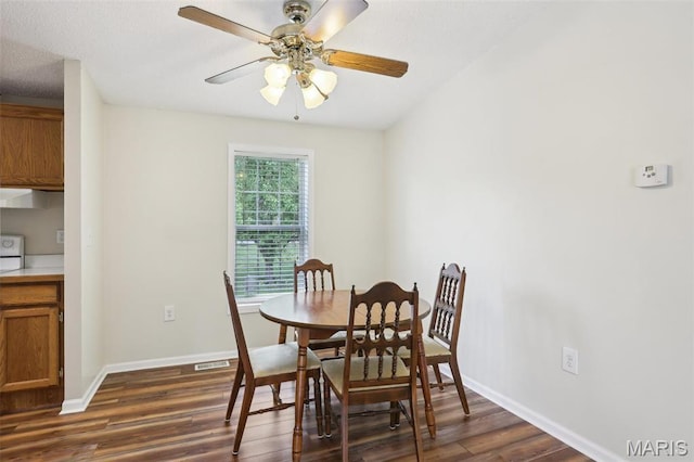 21839 Dove Ln, Carlyle, IL 62231 - dining area featuring dark wood-style flooring, a ceiling fan, and baseboards