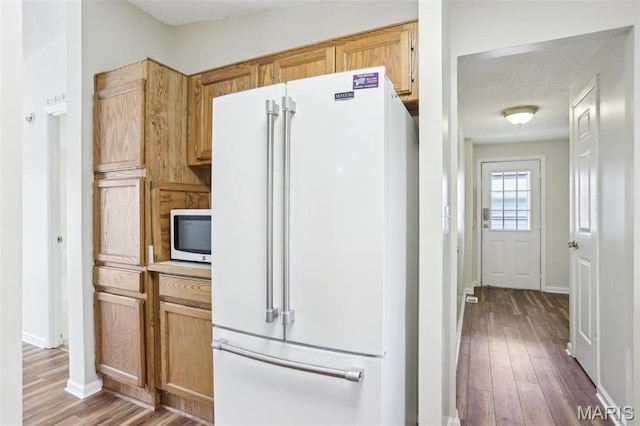 21839 Dove Ln, Carlyle, IL 62231 - kitchen featuring white appliances, wood finished floors, baseboards, and light countertops