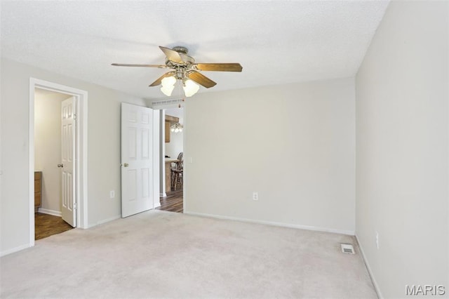 21839 Dove Ln, Carlyle, IL 62231 - unfurnished bedroom with carpet floors, baseboards, a ceiling fan, and a textured ceiling