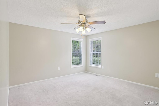 21839 Dove Ln, Carlyle, IL 62231 - empty room with light carpet, ceiling fan, baseboards, and a textured ceiling