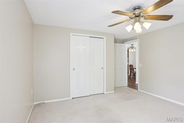 21839 Dove Ln, Carlyle, IL 62231 - unfurnished bedroom featuring baseboards, light colored carpet, a closet, and ceiling fan