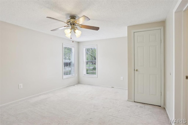 21839 Dove Ln, Carlyle, IL 62231 - spare room with a ceiling fan, a textured ceiling, carpet flooring, and baseboards