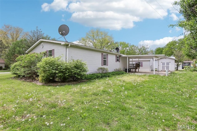 21839 Dove Ln, Carlyle, IL 62231 - rear view of property with a yard, a carport, and an outdoor structure
