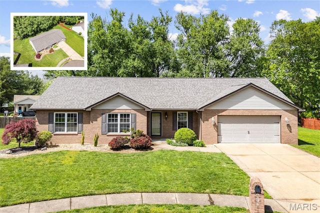 single story home featuring brick siding, an attached garage, driveway, a front yard, and roof with shingles