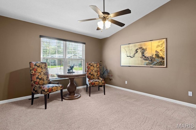 sitting room with carpet, baseboards, vaulted ceiling, and ceiling fan
