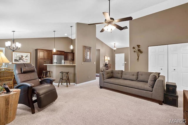 living room featuring light carpet, a ceiling fan, high vaulted ceiling, baseboards, and a chandelier