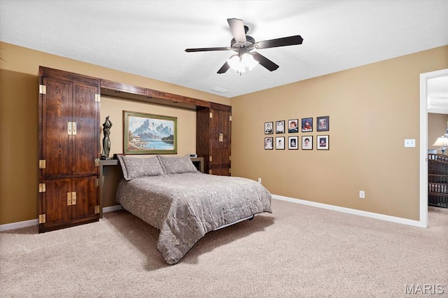 bedroom featuring light carpet, baseboards, and a ceiling fan