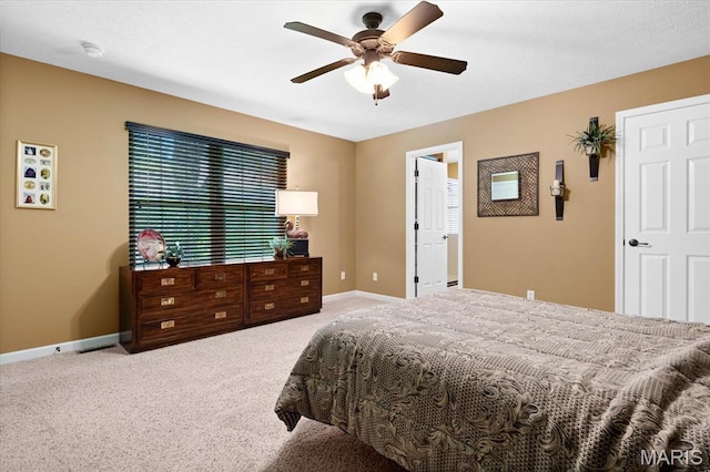carpeted bedroom featuring baseboards and a ceiling fan
