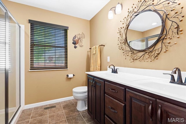full bath with a shower stall, toilet, baseboards, double vanity, and tile patterned flooring