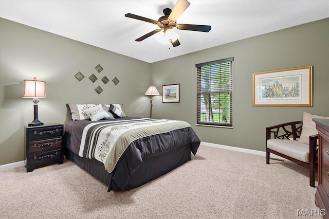 carpeted bedroom with baseboards and a ceiling fan