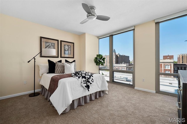 4909 Laclede Ave Unit 805, Saint Louis, MO 63108 - bedroom featuring a wall of windows, a view of city, carpet flooring, and ceiling fan
