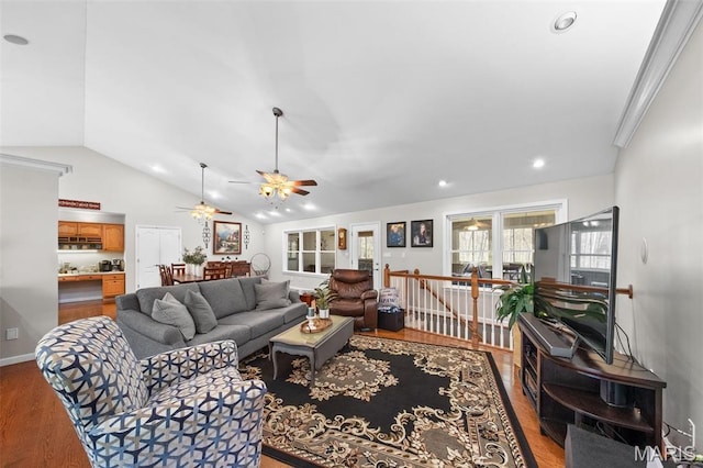 living area featuring lofted ceiling, ceiling fan, wood finished floors, and recessed lighting