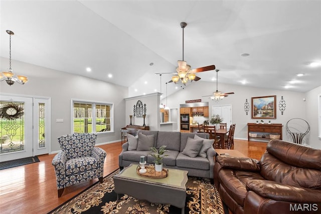 living area with ceiling fan, wood finished floors, high vaulted ceiling, a chandelier, and recessed lighting