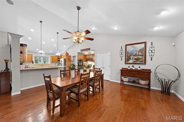 dining room featuring dark wood-style floors, ceiling fan, vaulted ceiling, baseboards, and recessed lighting