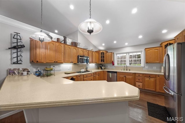 kitchen with appliances with stainless steel finishes, a peninsula, glass insert cabinets, light countertops, and recessed lighting