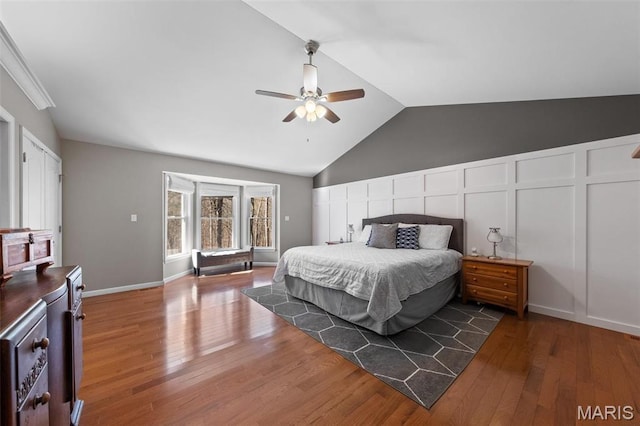 bedroom featuring wood finished floors, lofted ceiling, and ceiling fan