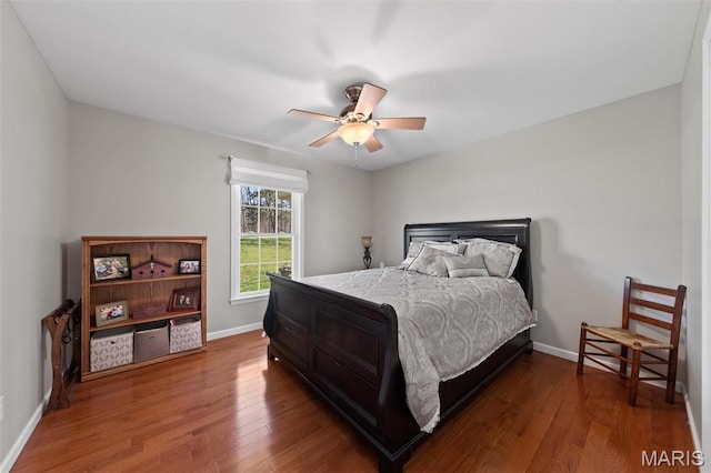 bedroom featuring wood finished floors, baseboards, and ceiling fan