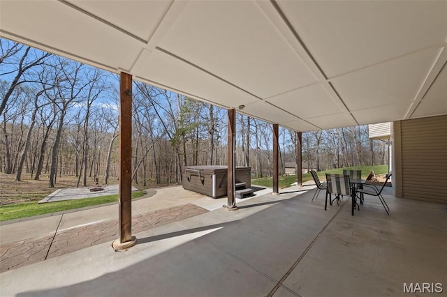 view of patio featuring a hot tub and outdoor dining space