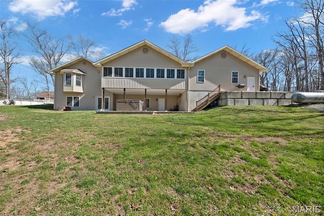 back of property with a yard and stairway