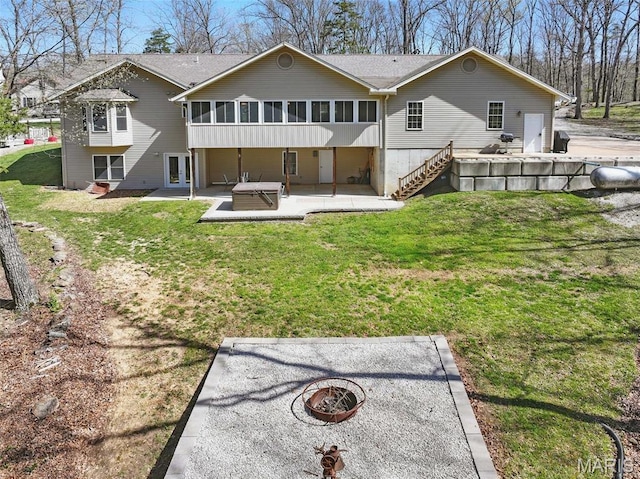 back of property featuring an outdoor fire pit, a sunroom, a patio area, french doors, and a yard