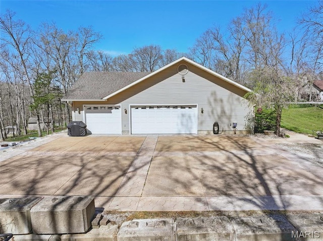 view of home's exterior featuring concrete driveway