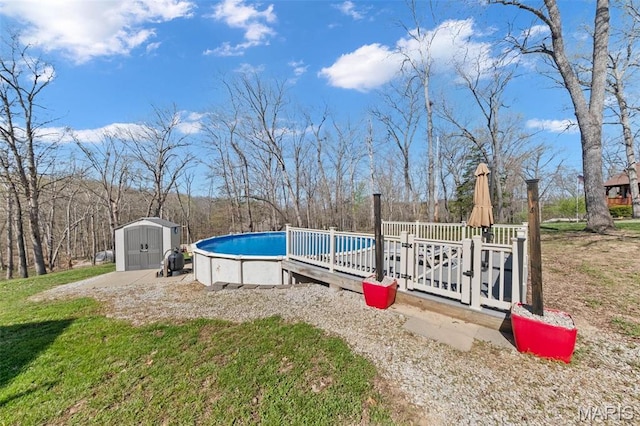 swimming pool featuring a storage unit, an outdoor structure, and fence