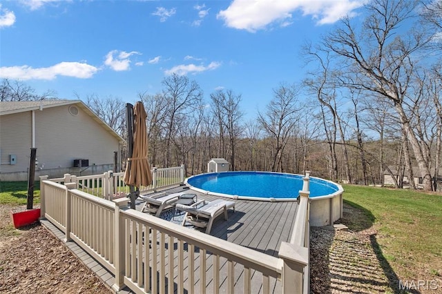 swimming pool featuring a deck and a lawn