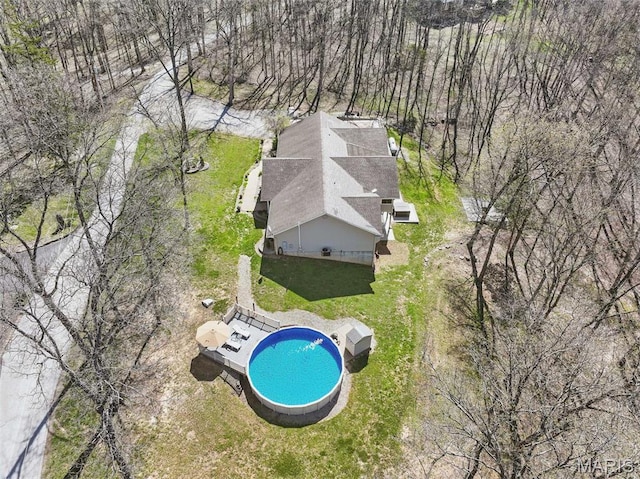 view of subject property with a pool