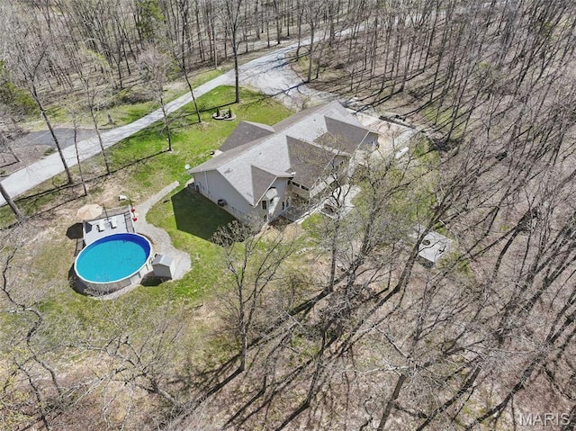 view of subject property with a pool