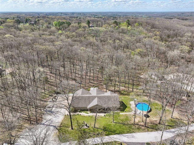 drone / aerial view of a forest and a pool