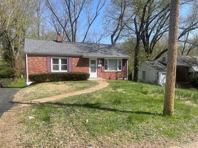 212 S Marguerite, Ferguson, MO 63135 - view of front facade with brick siding, a chimney, a front yard, and a shingled roof