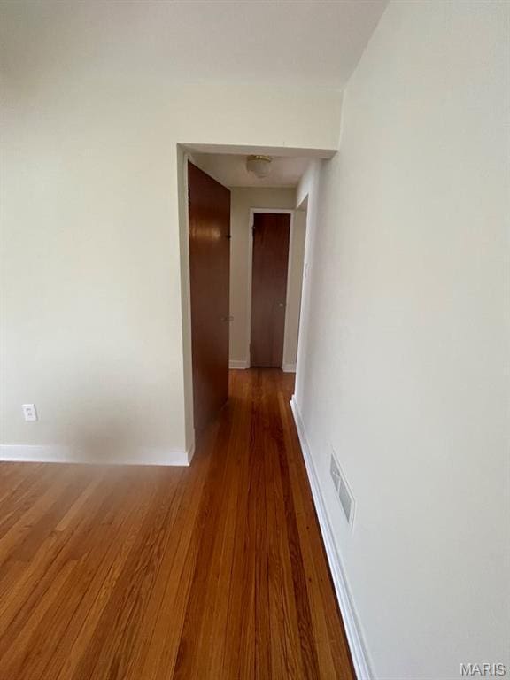 212 S Marguerite, Ferguson, MO 63135 - corridor featuring baseboards and wood finished floors