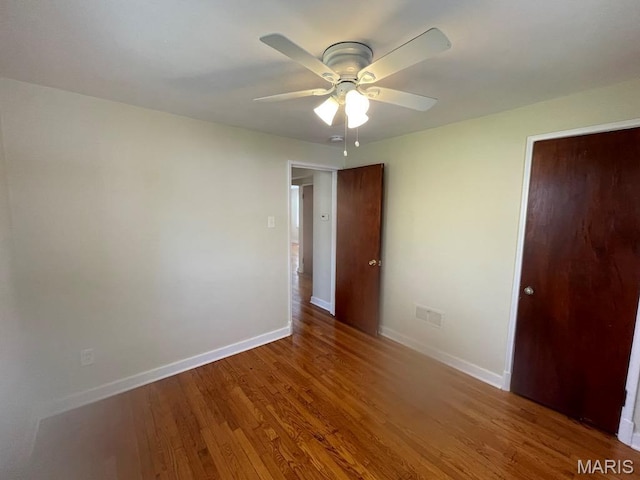 212 S Marguerite, Ferguson, MO 63135 - empty room with baseboards, a ceiling fan, and wood finished floors