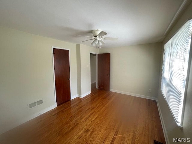 212 S Marguerite, Ferguson, MO 63135 - unfurnished bedroom featuring wood finished floors, baseboards, ceiling fan, and a closet