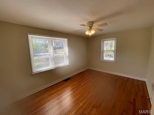 212 S Marguerite, Ferguson, MO 63135 - empty room featuring baseboards, wood finished floors, and a ceiling fan