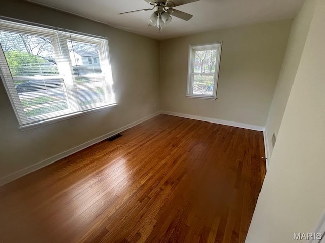 212 S Marguerite, Ferguson, MO 63135 - empty room featuring wood finished floors, ceiling fan, and baseboards