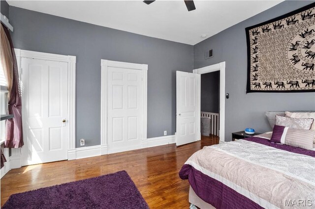 bedroom with wood finished floors, ceiling fan, and baseboards