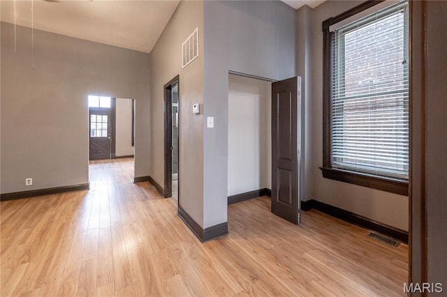 entryway with light wood finished floors and baseboards
