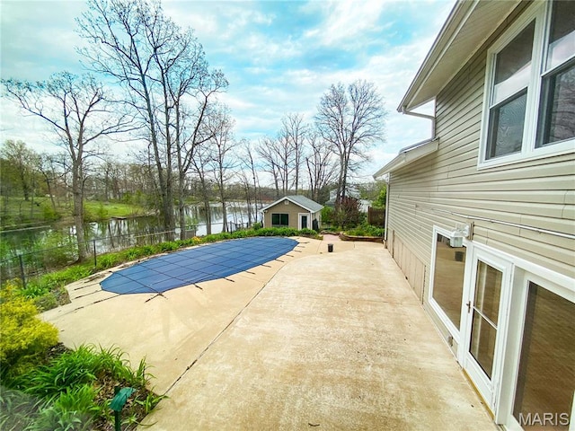 19113 Bent Oak Dr, Warrenton, MO 63383 - view of swimming pool featuring a water view, a patio area, and an outbuilding