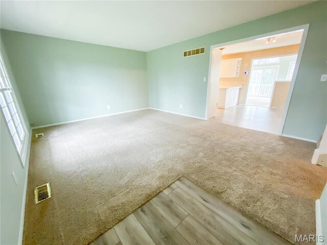 19113 Bent Oak Dr, Warrenton, MO 63383 - spare room featuring carpet floors and wood finished floors